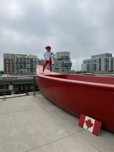 Diana dancing on top the big red canoe at Fort York, Canoe Landing park while filming Jerusalema in the SIX.